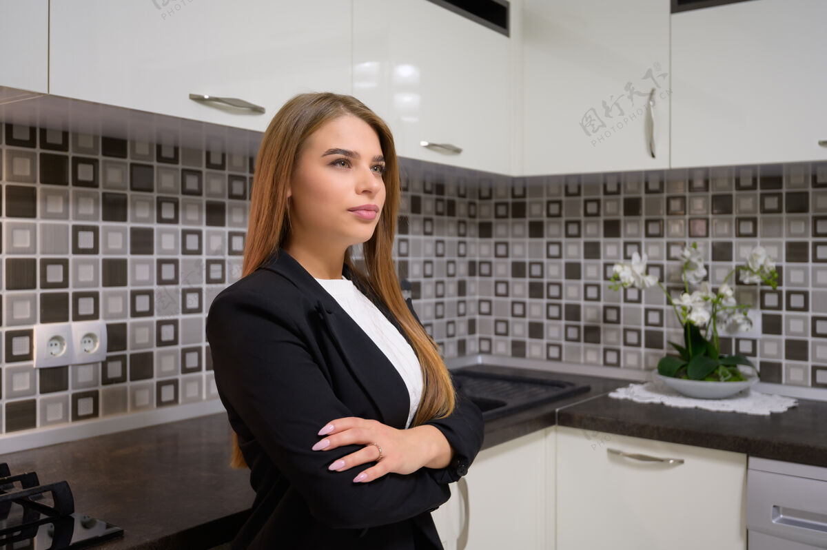商务年轻漂亮的女人在豪华现代黑白厨房室内设计干净门电器古典