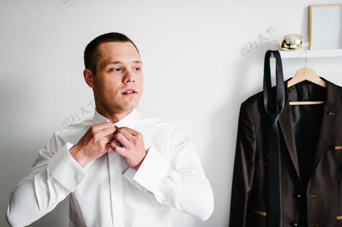 衣服男更衣室家男人他身上的扣子衬衫 衣服概念年轻男人新郎