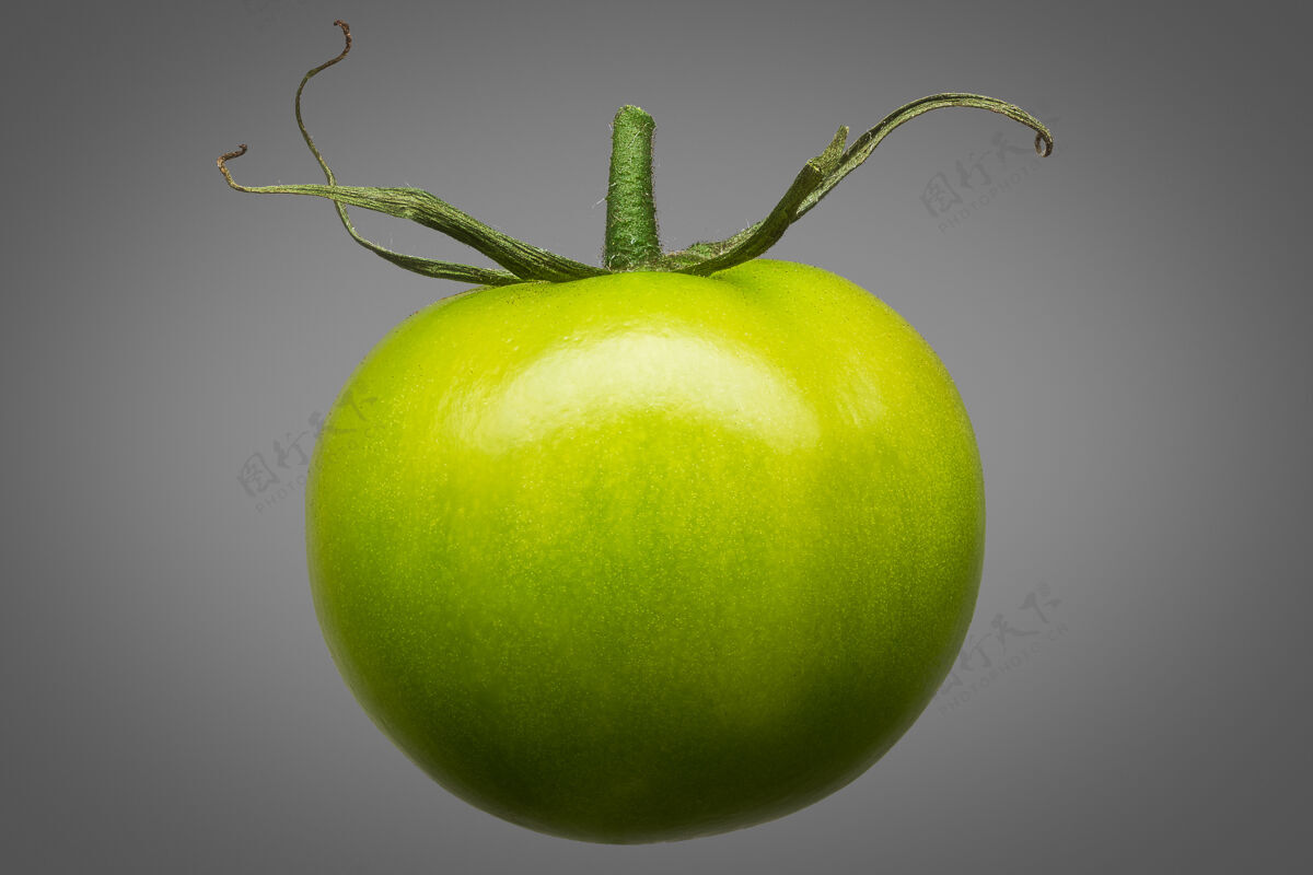 光泽美味的单一绿色番茄隔离在灰色背景与剪辑路径美味自然美味