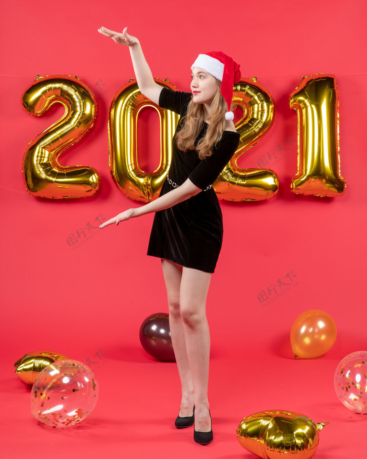 小姐正面图：身穿黑色连衣裙的年轻女士 手上拿着红色气球 展示身材前面成人黄铜