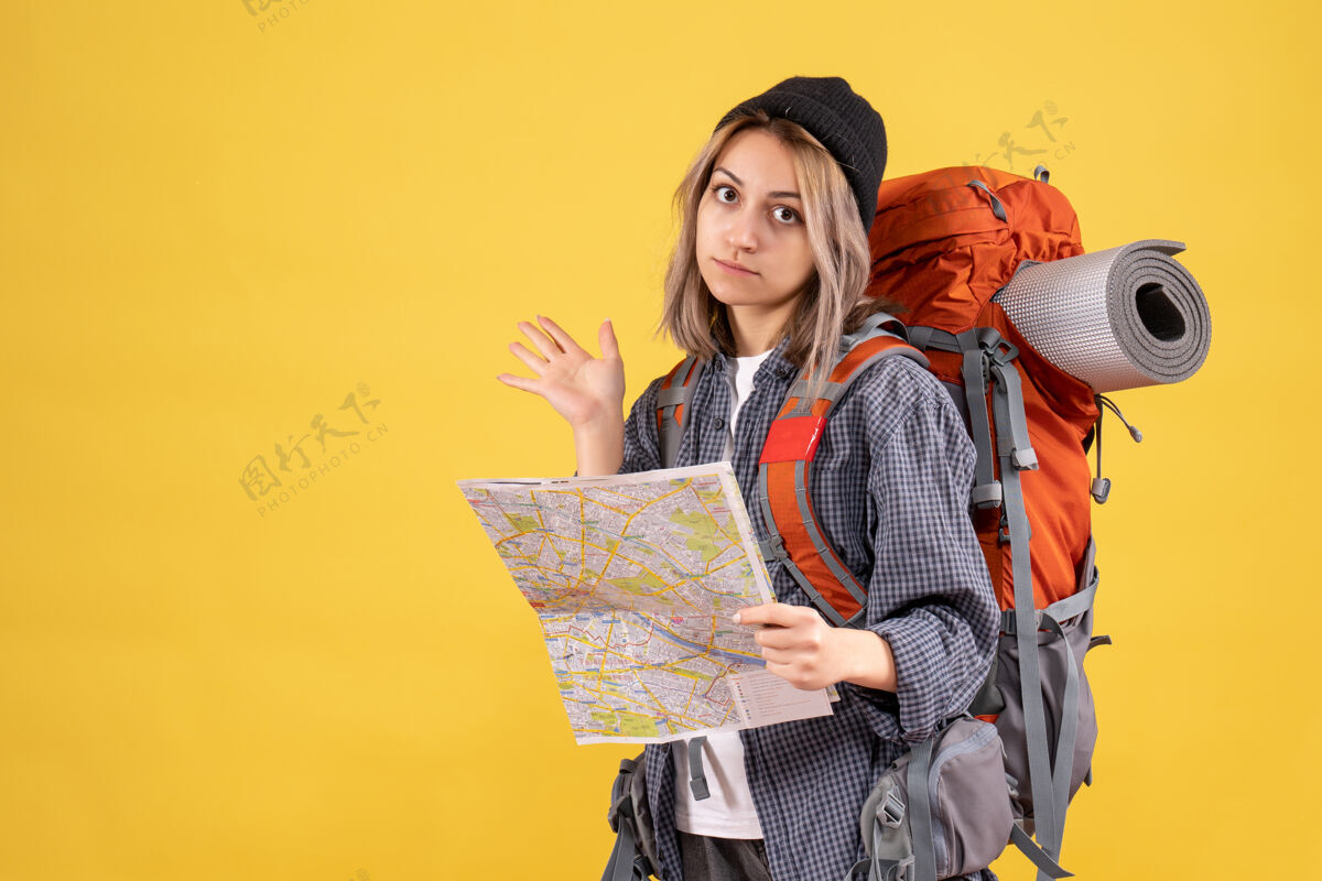 成人背着背包拿着黄色地图的女旅行者女旅行者人黄色