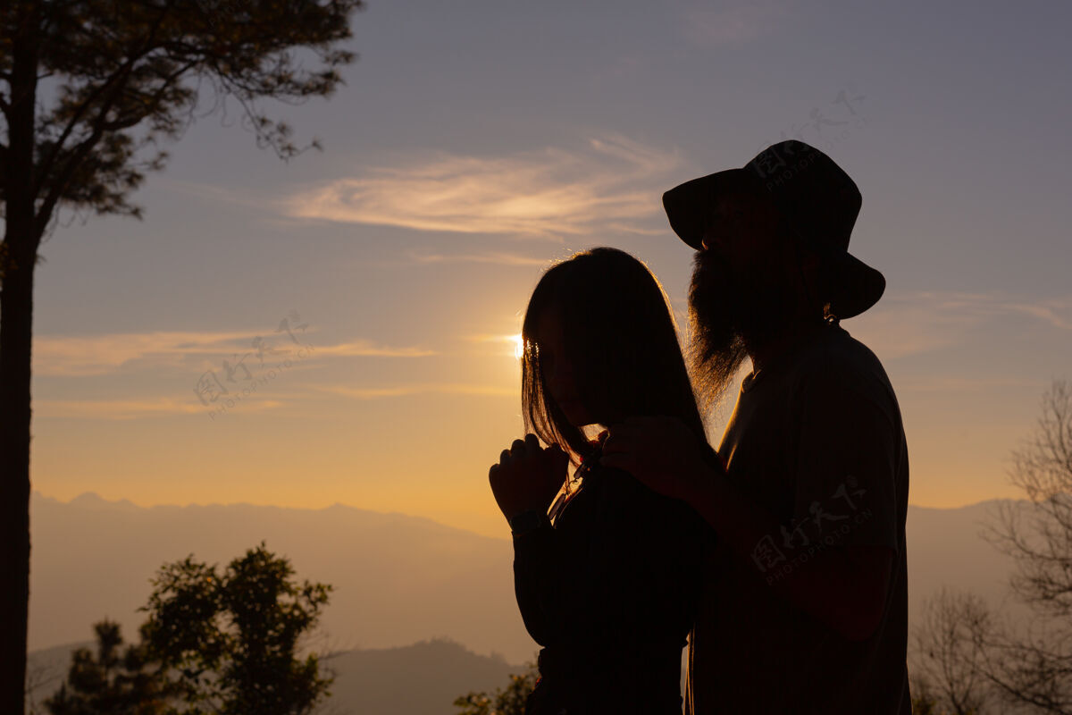 爱在山上欣赏日落的年轻夫妇二人男人日落