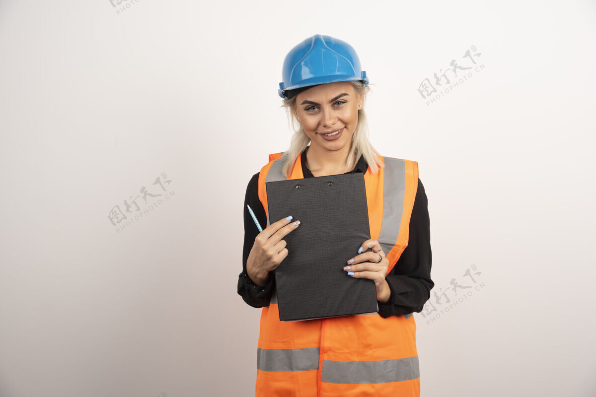 背心女工人拿着白色背景的剪贴板高质量的照片工人剪贴板安全帽