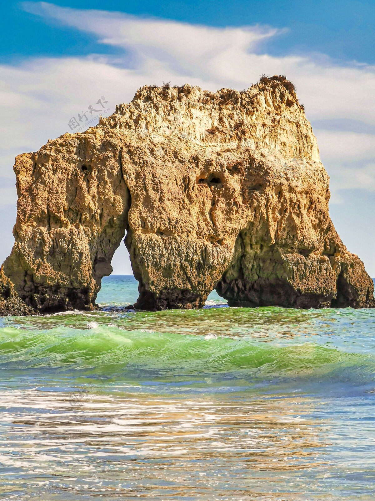 海滩垂直拍摄的海浪经过一块大岩石海洋游泳大海