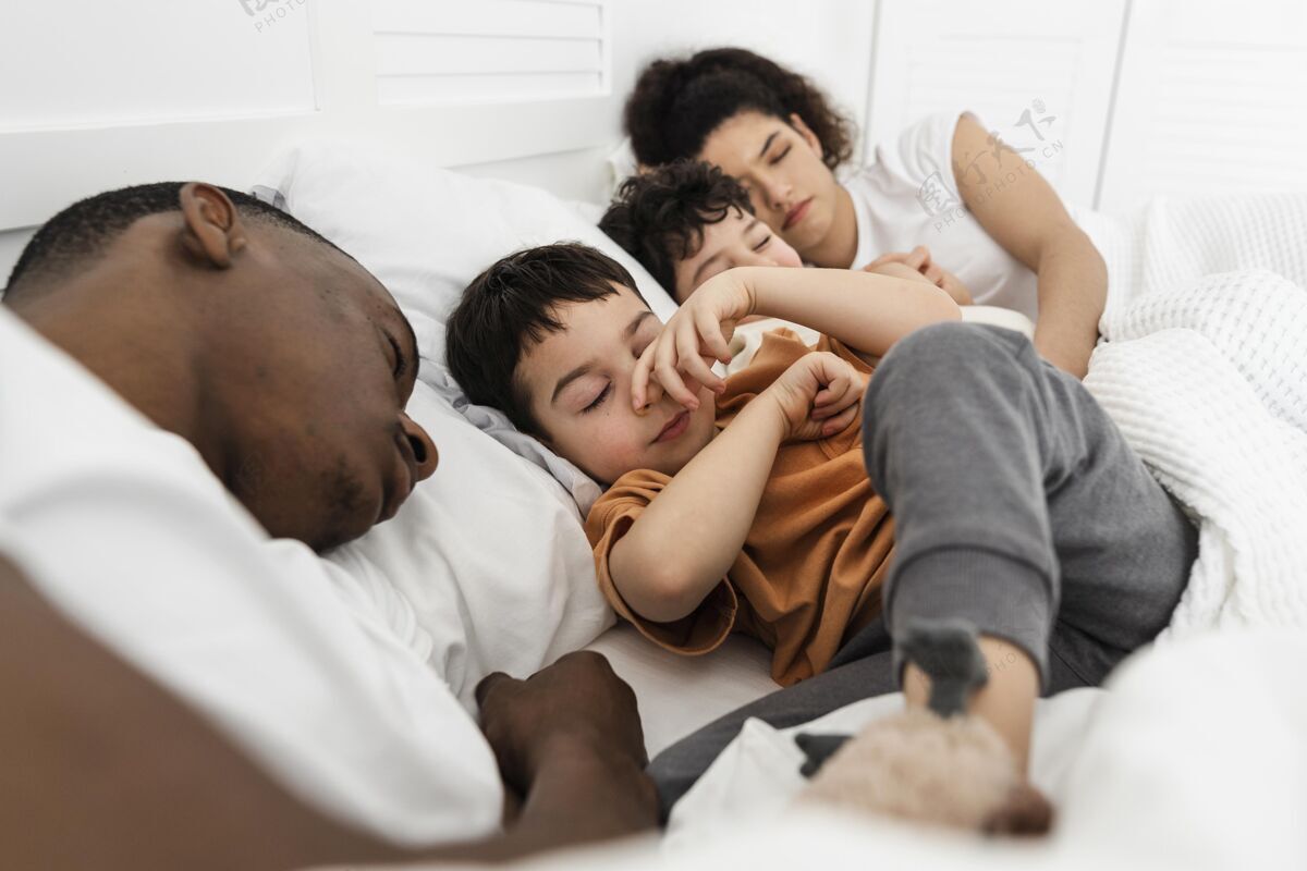 就寝时间可爱的孩子试图睡在父母的床上卧室床父亲
