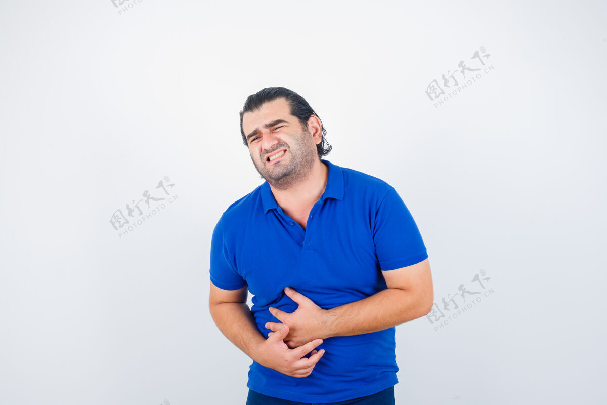 前面身穿蓝色t恤的中年男子胃痛难忍 面容不适 正面照医学年龄发烧