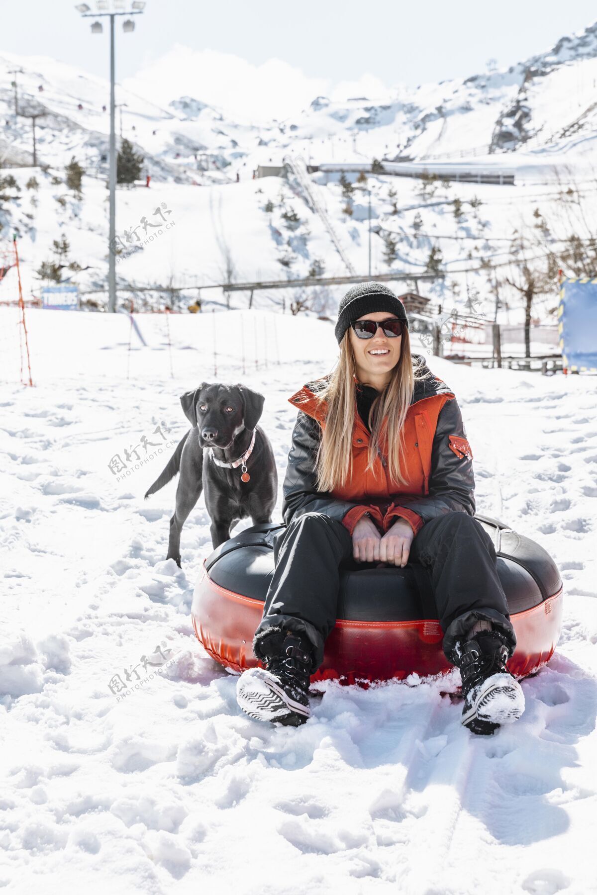 冬天坐在户外和狗在一起的全镜头女人狗自然雪