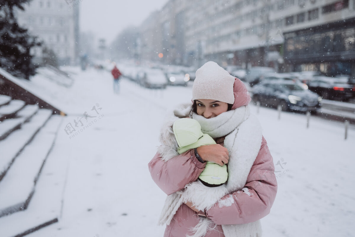 冬天抱着狗的女孩下雪了外面穿风格