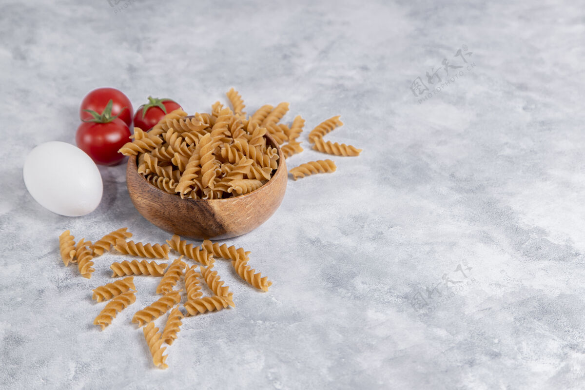 堆一个木制的意大利生面碗 上面有西红柿高质量的照片生的餐生的食物