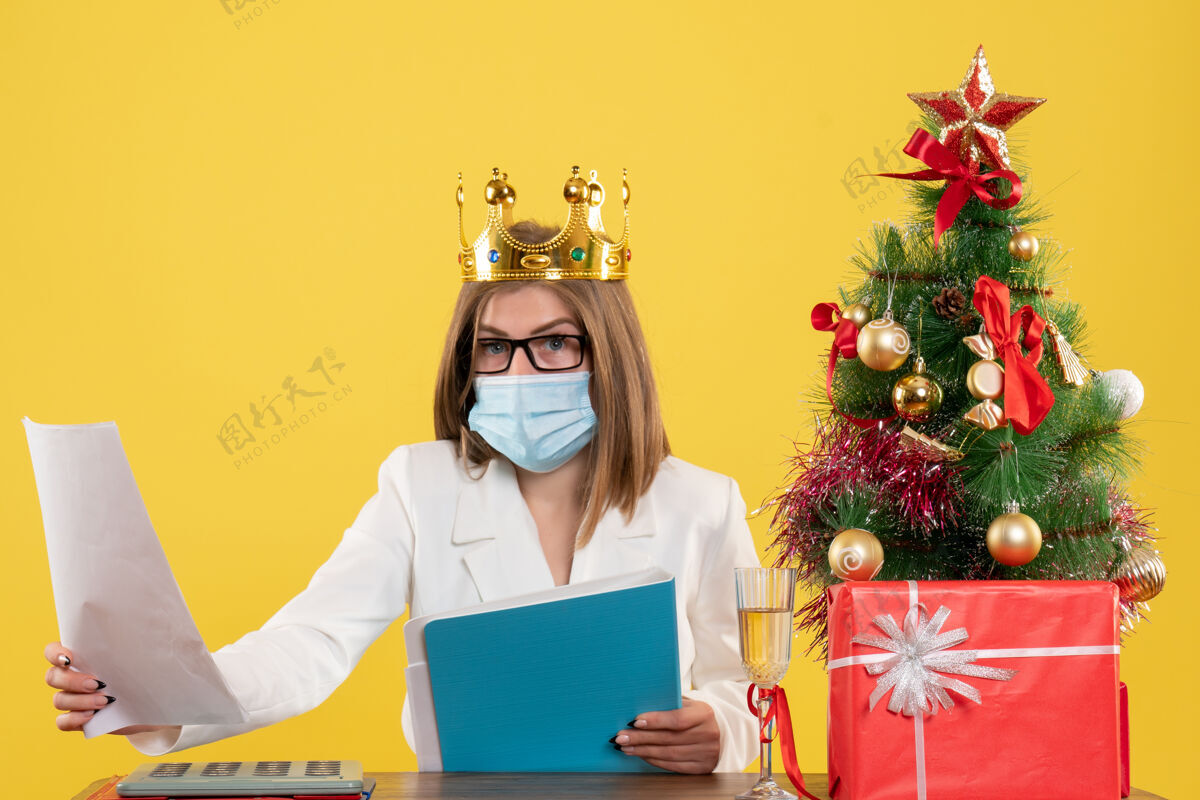 颜色前视图女医生带着文件戴着无菌口罩人成人笔记本电脑