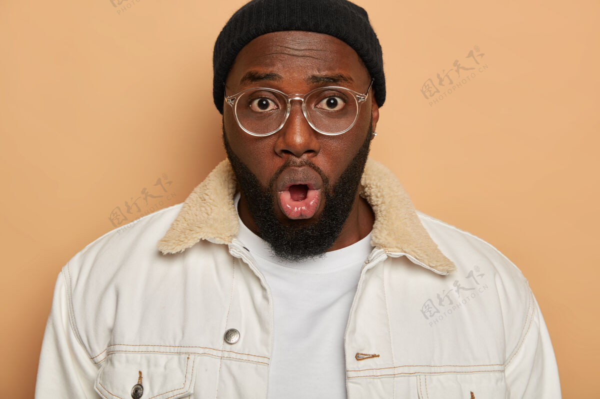 成年人情绪化的黑皮肤男人的特写肖像留着厚厚的胡茬 戴着眼镜男人表情非洲人