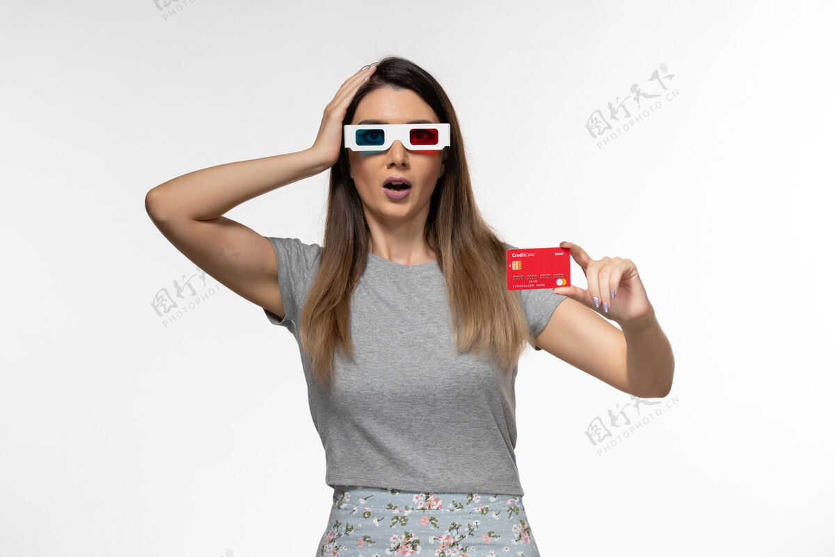 太阳镜正面图年轻女性手持红色银行卡戴着d墨镜在浅白的表面孤独持有电影