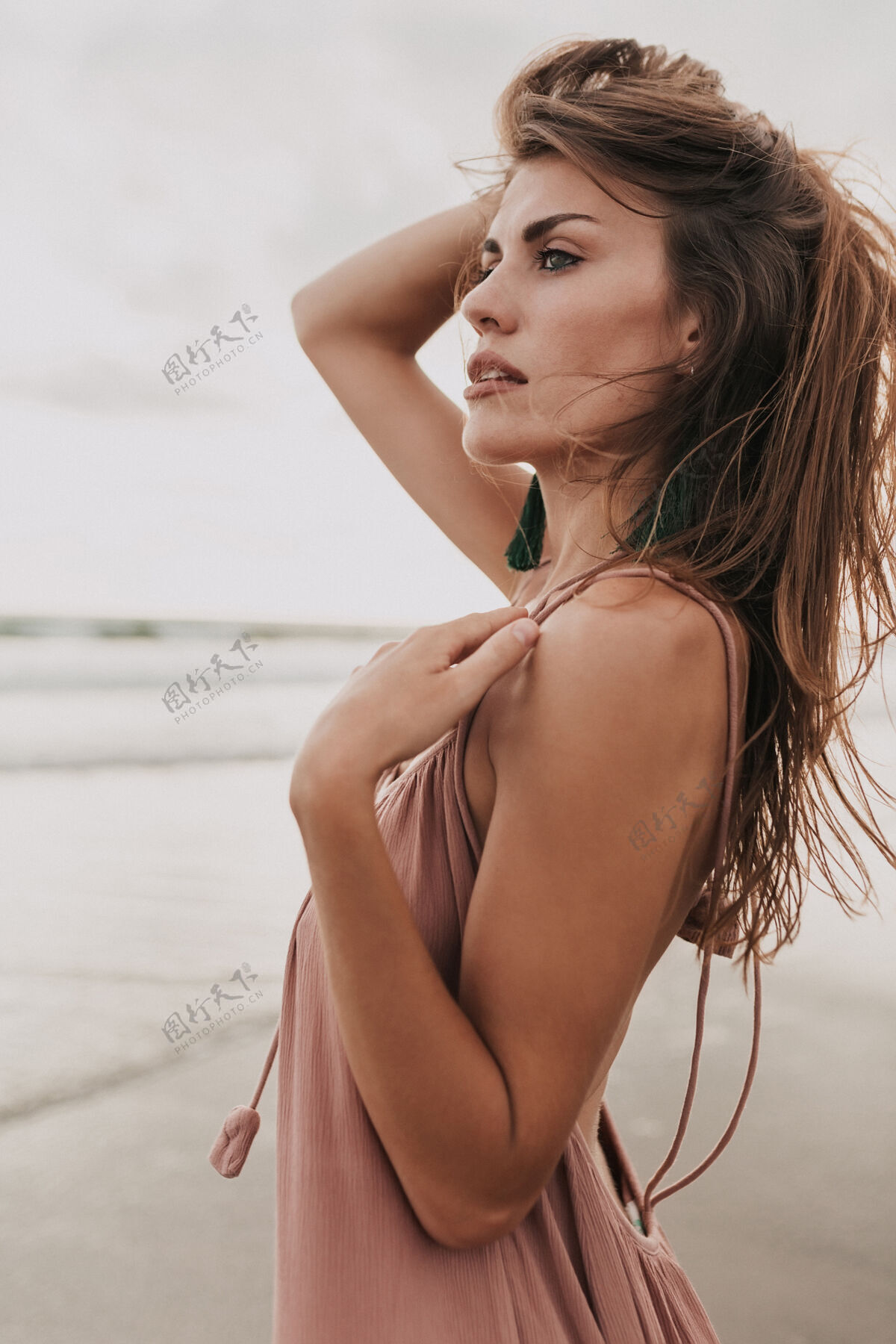 海滩在夏日温暖的日子里 穿着夏装的时髦女人在海边摆姿势美丽热带沙滩