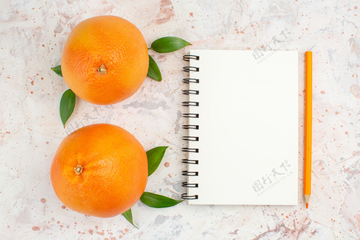 观点顶视图新鲜橙子笔记本橙色铅笔明亮的孤立表面铅笔顶部新鲜的橙子