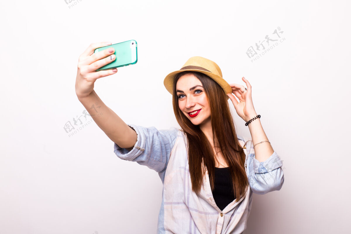 女性微笑的年轻女子在灰色的智能手机上自拍爱情年轻行政