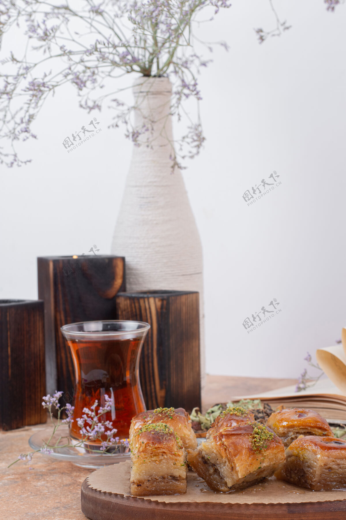 盘子一杯茶和传统的开心果烤熔岩放在大理石桌上甜点吃杯子