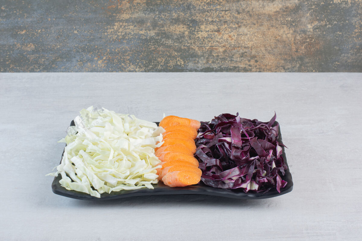 蔬菜切碎的胡萝卜 红白的卷心菜放在黑盘子里高质量的照片天然健康胡萝卜