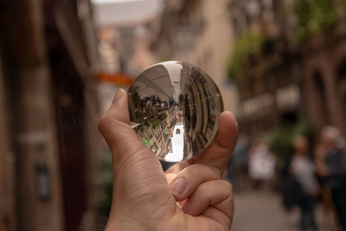 水特写镜头一个人拿着一个水晶球与历史建筑的反映财富历史发光